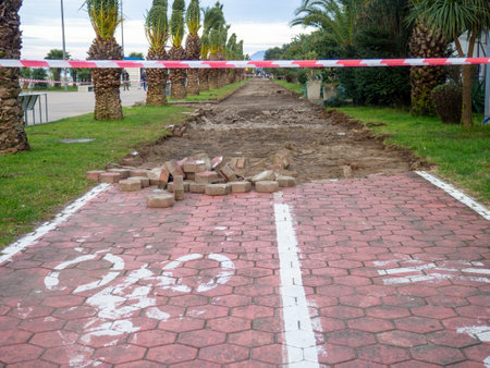 Reconstruction of the bike path. Replacing tiles on a bike path among palm trees. Infrastructure of the resort town.の写真素材