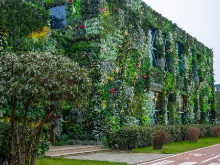 exterior of the house is decorated with artificial flowers. House facade design. Green building. A bold decision in architecture.の写真素材