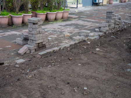 Renovation of the pedestrian zone. Excavation. Laying tiles outdoors. Concrete tiles. Infrastructure repairの写真素材