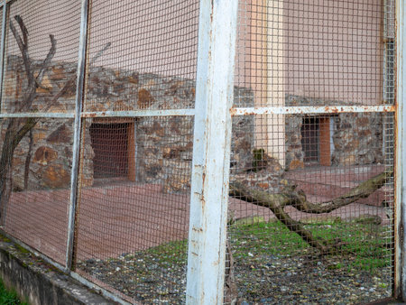 Outdoor fence at the zoo. Empty cages in the zoo. Winter at the zoo. The animals hid. Empty animal enclosure. Latticeの写真素材