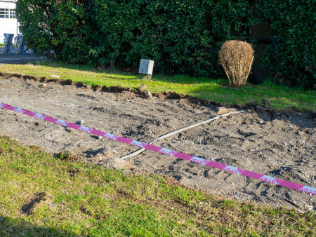 Repair work in the park. Fencing tape near the lawn. Fenced area. No entry. No passage conceptの写真素材
