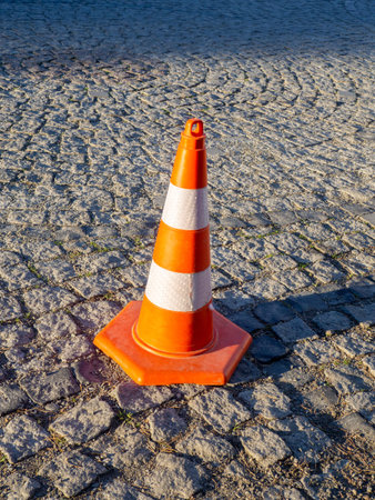 Traffic cones on paving stones. Traffic regulation. Parking. Orange signs
