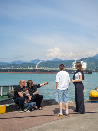 Batumi, Georgia. 10/05/2024 atmosphere of a seaport. Pier at the cargo port. People relax on the embankment. Batumi seaport. People at their activitiesのeditorial素材