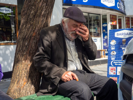 Batumi, Georgia. 10/05/2024 Poverty concept. Grieving old man on a bench. Elderly man covering his face with his handのeditorial素材