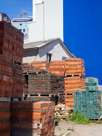 Sale of construction materials on the street. Open air market for building materials. A bunch of bricks in sleepers. Construction preparation conceptの写真素材