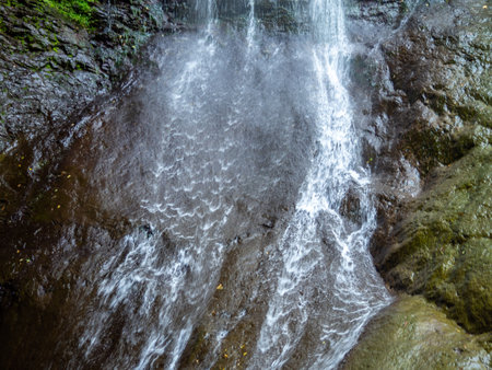 Waterfall in the mountains. Vertical flow of water. Nature of Georgia. Makhuntseti Waterfallの写真素材