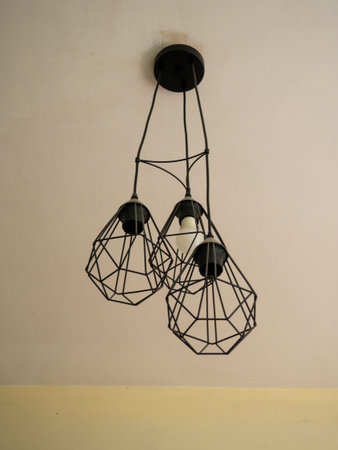 Three platforms chandelier. Lighting fixture. There are not enough bulbs in the chandelier. Interior elementの写真素材