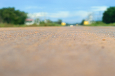 Long empty road ahead into the city filled with cars, defocused backgroundの写真素材