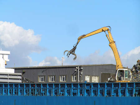 Crane loading scrap carsの写真素材