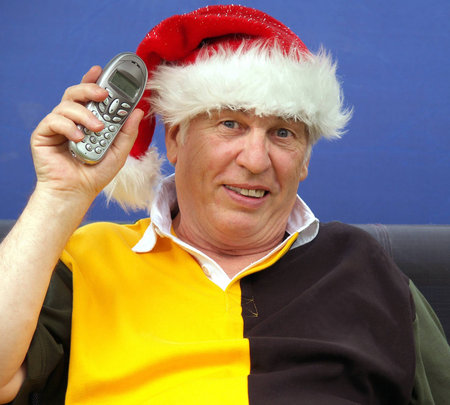 Mature male with telephone at christmas        