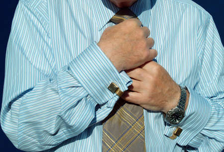 Straightening tie and getting ready for work        の写真素材