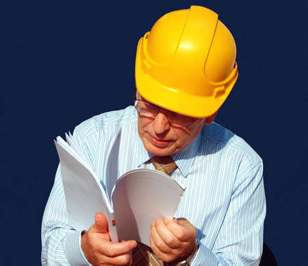 Architect checking his  instructions very carefully       の写真素材