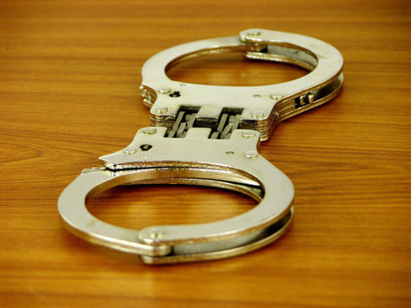 Handcuffs Focus on locks making photo dramatic         の写真素材