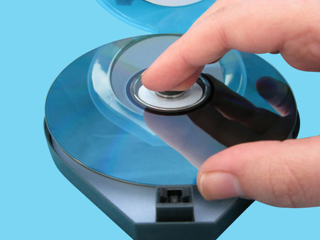 Loading a disc female hand with reflections