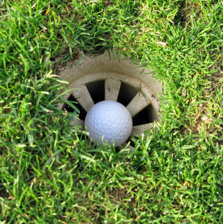 In the hole with grass filling it tooの写真素材