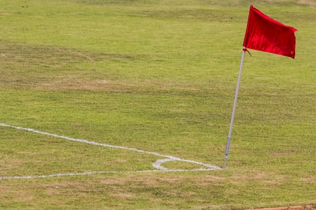 old football field with red flag の写真素材