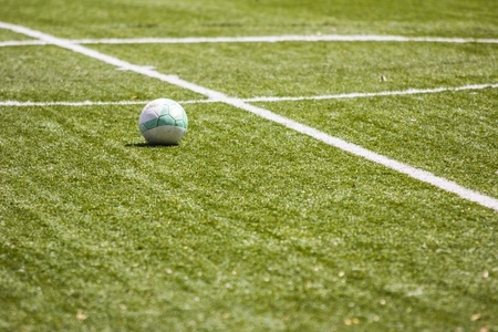 Sports background - soccer ball in green stadiumの写真素材