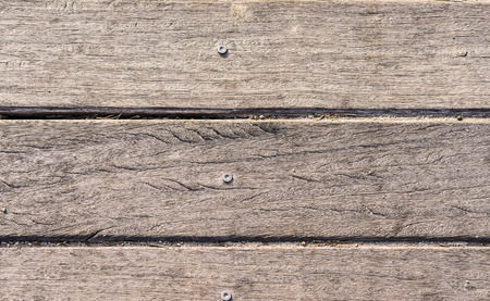 wooden slats with screw horizontally on the beach worn by the sun backgroundの写真素材