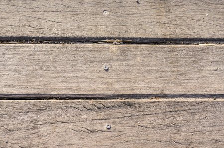wooden slats with screw horizontally on the beach worn by the sun backgroundの写真素材