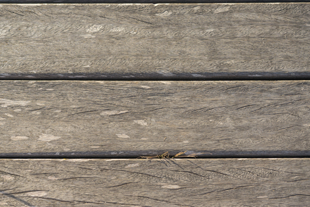 wooden slats horizontally on the beach worn by the sun backgroundの写真素材
