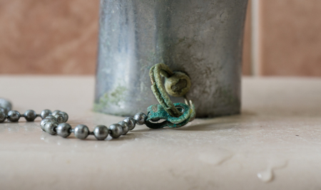 Calcium deposits on balls chain bathroom sink stopper on detailの写真素材