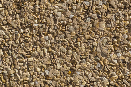 wallcovering with small pieces of different stones texture stone wall shades high contrastの写真素材