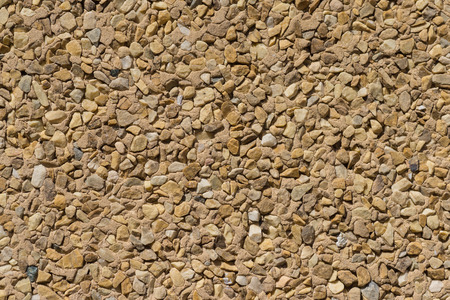 wallcovering with small pieces of different stones texture stone wallの写真素材