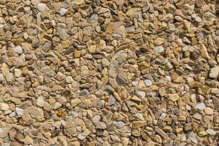 detail of wallcovering with small pieces of different stones texture stone wallの写真素材