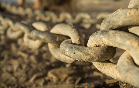 Close-up of links of a long iron chain in detailの写真素材