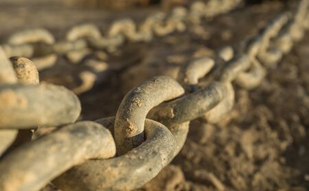 Close-up of links of a long iron chain in detailの写真素材