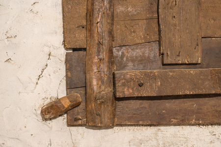 Wooden latch for an old window detail locks Wood with signs of wood wormの写真素材