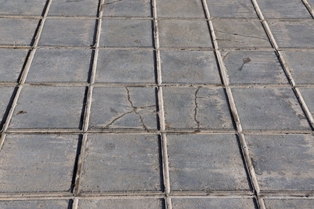 concrete tile for outdoor use Sidewalks, non-slip and wear resistance paving with tile Dirty and broken hydraulic tiles, perspective viewの写真素材