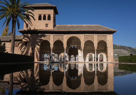 Alhambra Palace in Granada Spain palaces Nazaries, symmetrical reflection in the mirror of waterの写真素材