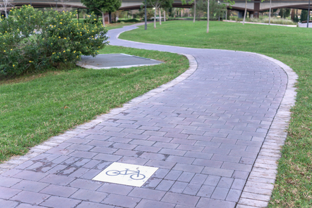 cycleway signposted a ground bikeway for cyclists only. Bike lane between trees in Jardin del Turia in Valencia Spainの写真素材