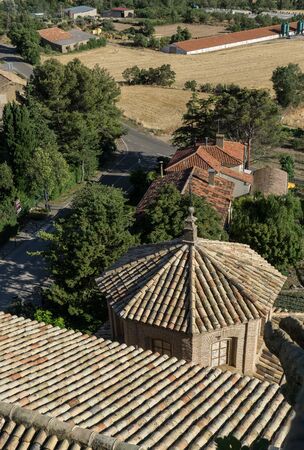 Aerial view of Shingle roof tile of chapel and Church of San Esteban built in the 18th century, Loarre Aragon Huesca Spain, and the road to the villageの写真素材