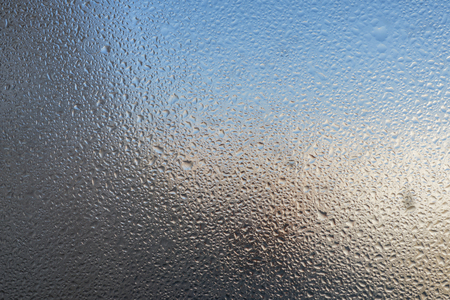 Closeup detail of Moisture condensation problems, hot water vapor condensed on the cold window glass, macroの写真素材
