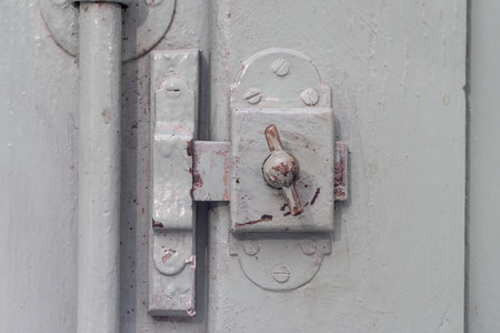 detail old window Lock on vintage wooden door, painted covering wood, metal and screwsの写真素材