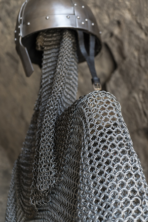 Helmet, chainmail, sword and shields of a medieval armor knight ready for battleの写真素材