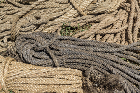 rope pattern formed by different colors of worn intertwined stringsの写真素材