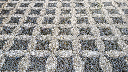 Cobbled pavement made of river rounded pebbles in Cordoba, Andalusia, Spain. Background texture. Patio Andaluzの写真素材