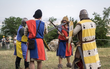Loarre, Spain - July 09, 2016: Medieval reenactment with costumed characters and medieval armor with chainmail, helmet swords and shields. Battle knight demonstration and recreationのeditorial素材