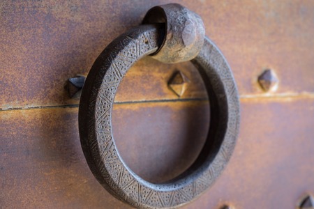 Closeup vintage door knocker of rusty iron doorの写真素材