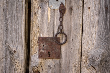 Closeup vintage door lock of external antique wooden door weathered on a Country houseの写真素材