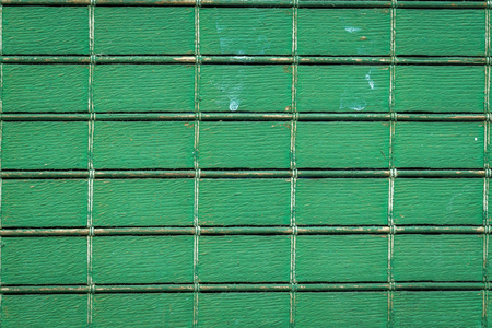 old lattice blinds detail painted green, planks of wood joined by ropesの写真素材