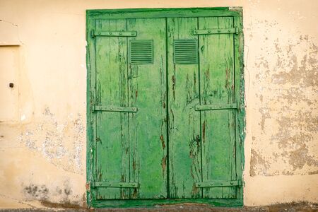 vintage door of external antique wooden door weathered on a Country house, green woodの写真素材