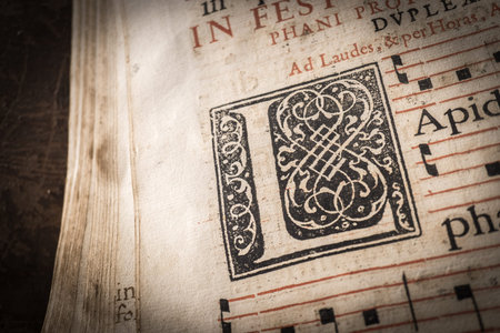 church choir books on a wooden lectern. detail of capital letter, macro, Very old deteriorated books...