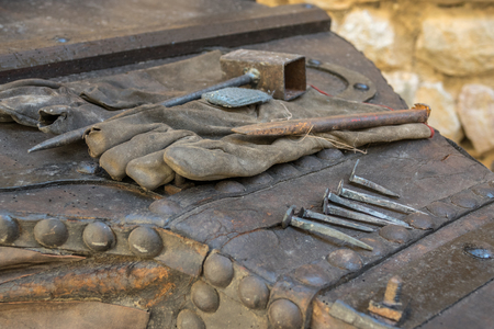 forging tools como hammer, iron parts to clear, tacks made as formerly were made, work glovesの写真素材