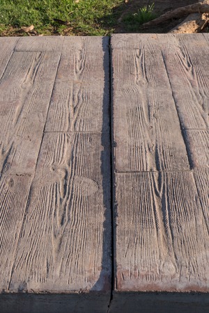 Expansion joint at stamped concrete pavement, Footprints that were marked when stepping when it was still freshの写真素材