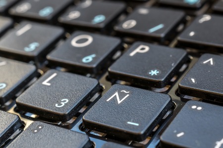 Close-up electronic of laptop keyboard with focus on Ã± button, keyboard for writing in Spanish, Castilianの写真素材