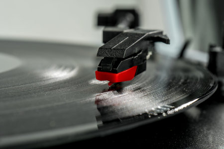 turntable stylus macro detail, needle reading the vinyl. Old record player stylus on a rotating...
